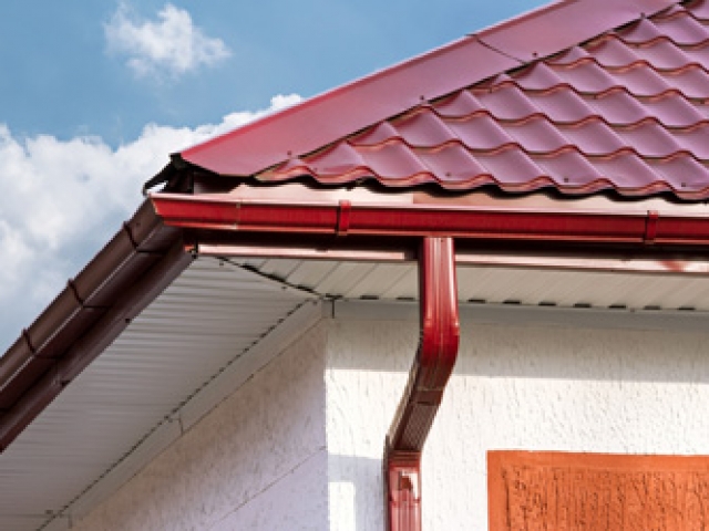 House roof, gutters and downspout on the corner of a house